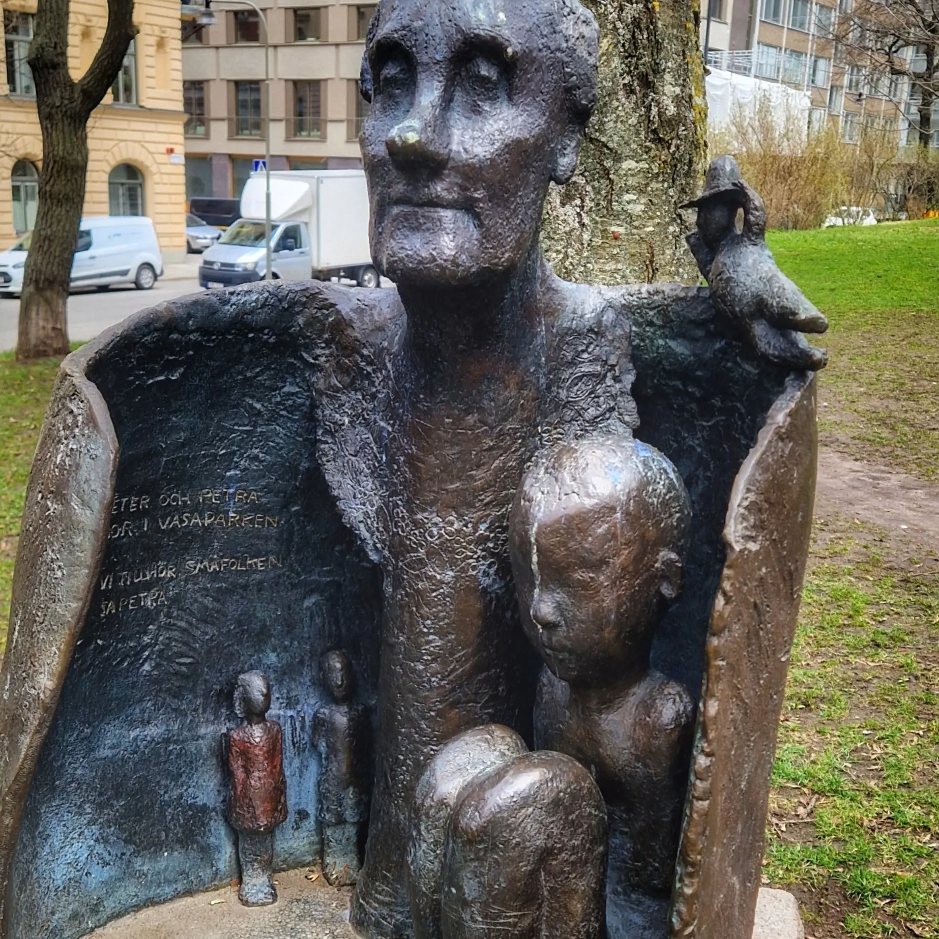 Bronsskulptur i Vasaparken. Texten "Peter och Petra" syns. En fågel med hatt sitter på skulpturen